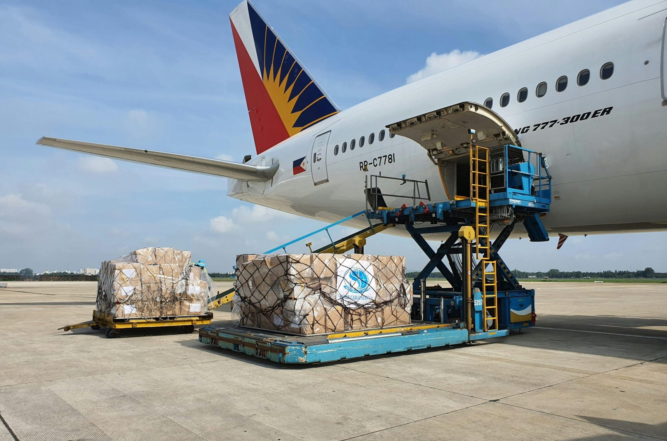Cargo being loaded onto a commercial airplane at an airport in Ho Chi Minh City, Vietnam.